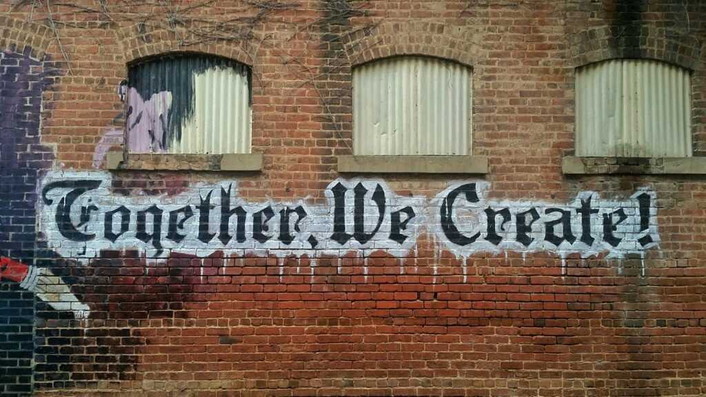Christian Marketing “Together, we create!” on brick wall
